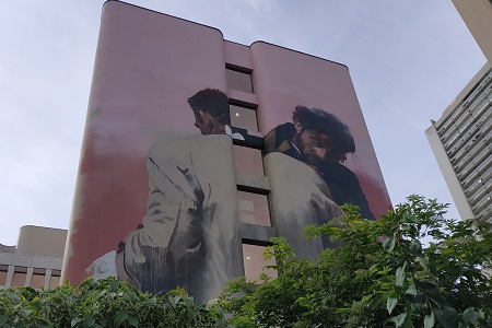 photo of the street art fresco in Paris 13 by Conor, entitled: Embrace and Struggle